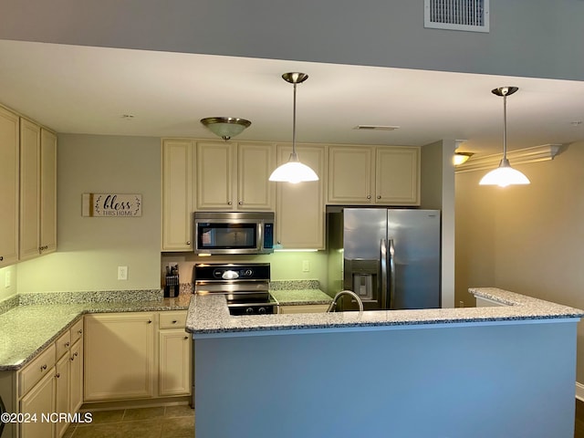 kitchen featuring decorative light fixtures, stainless steel appliances, and light stone counters