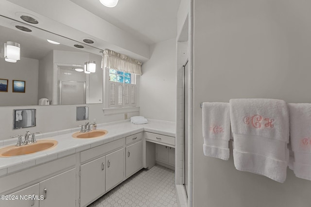 bathroom with vanity and a shower with door