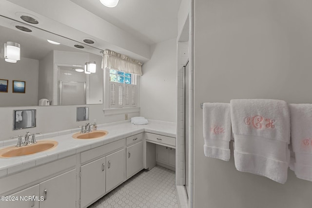 bathroom with a stall shower, tile patterned floors, and double vanity