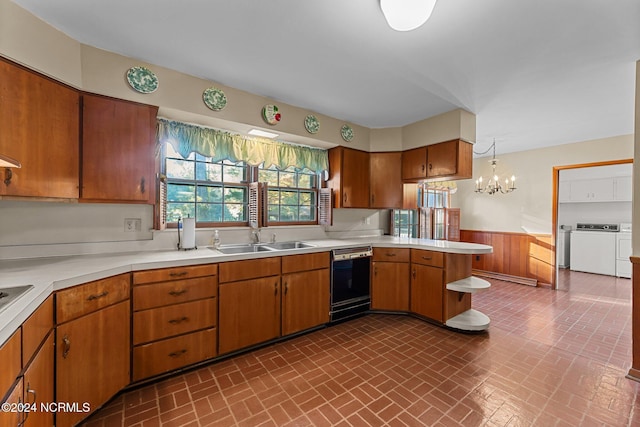 kitchen featuring dishwasher, a sink, washer and clothes dryer, light countertops, and a wainscoted wall