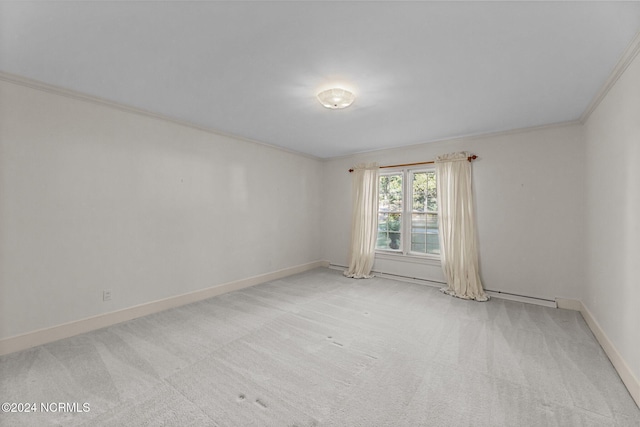 carpeted empty room featuring ornamental molding and baseboards