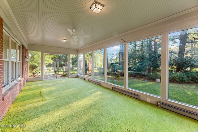 unfurnished sunroom featuring ceiling fan and baseboard heating
