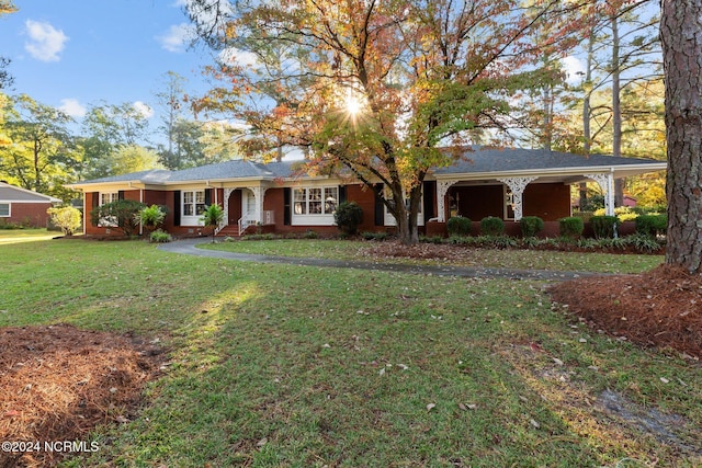 ranch-style house with a front lawn, a porch, and brick siding