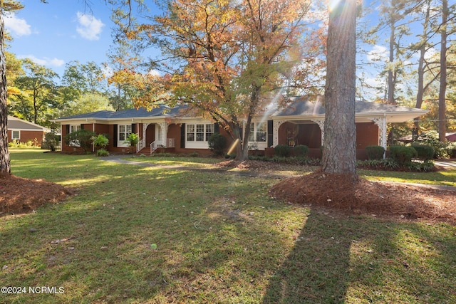 ranch-style home with covered porch and a front yard