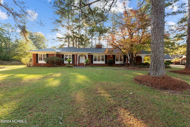 single story home with a chimney and brick siding