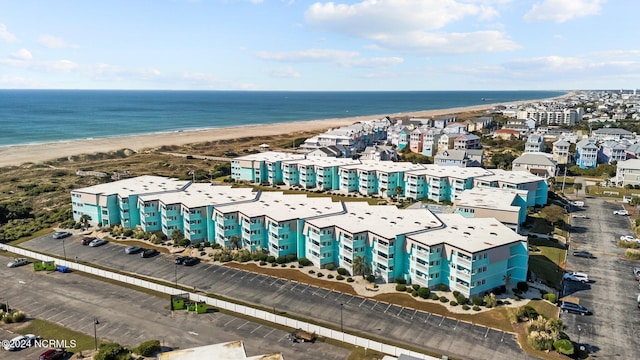 aerial view with a water view and a beach view