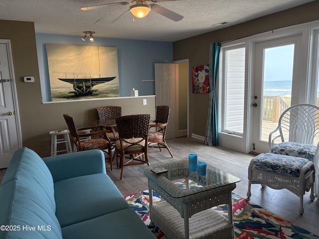 3307 Ocean Dr Unit 2, Emerald Isle, NC 28594 - living area featuring a textured ceiling, wood finished floors, and ceiling fan
