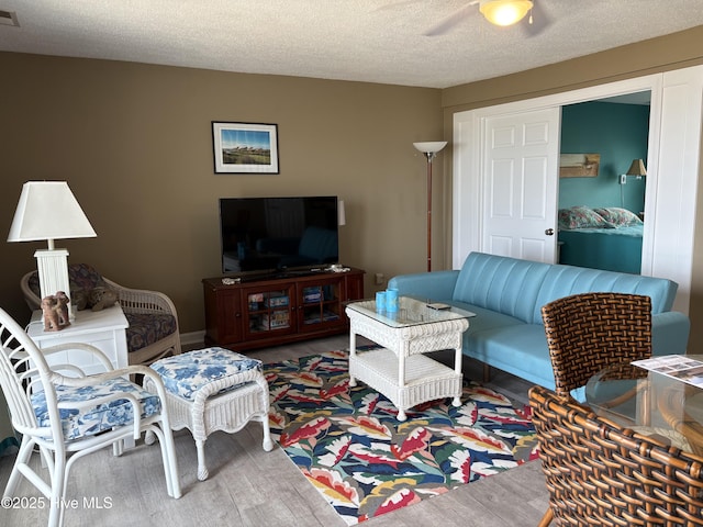 3307 Ocean Dr Unit 2, Emerald Isle, NC 28594 - living room featuring wood finished floors, ceiling fan, and a textured ceiling