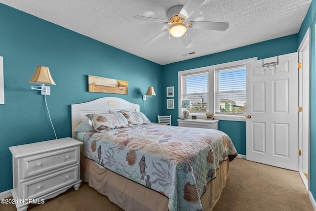 bedroom featuring carpet floors, a textured ceiling, baseboards, and ceiling fan