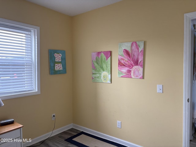 3307 Ocean Dr Unit 2, Emerald Isle, NC 28594 - spare room featuring baseboards and wood finished floors