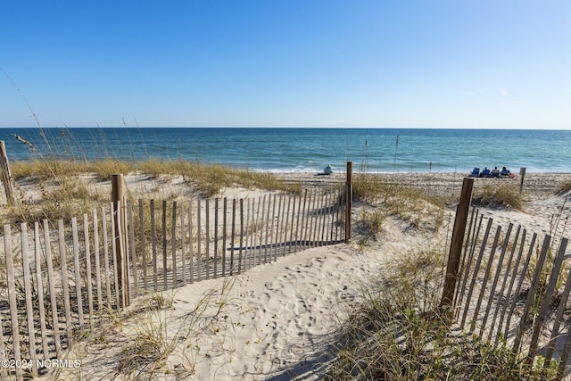 water view with nearby beach and fence