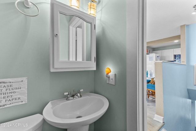 3307 Ocean Dr Unit 2, Emerald Isle, NC 28594 - bathroom with a sink, toilet, and wood finished floors