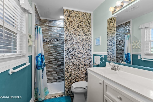 full bath featuring a stall shower, toilet, vanity, and tile patterned floors