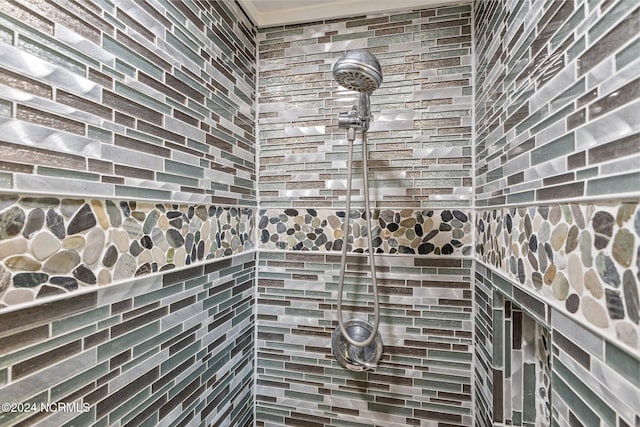 bathroom with tiled shower