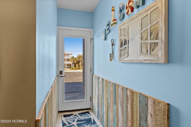 doorway to outside featuring light tile patterned flooring