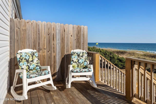 deck featuring a water view and a beach view