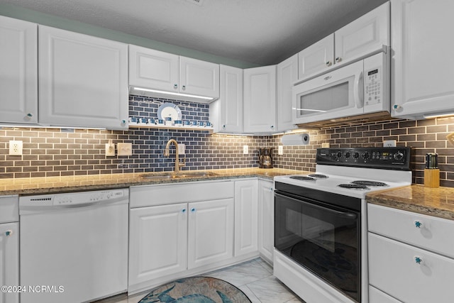 kitchen featuring white appliances, a sink, white cabinets, and light marble finish flooring