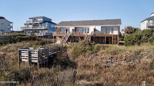 back of property with stairs and a wooden deck