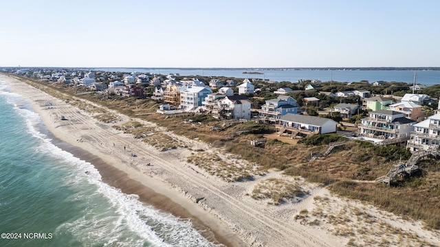 birds eye view of property with a beach view and a water view