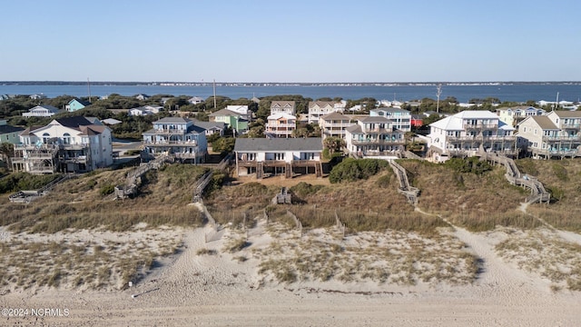 aerial perspective of suburban area with a large body of water