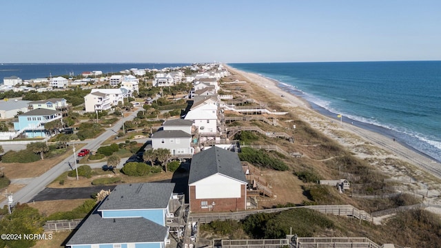 birds eye view of property with a water view and a beach view