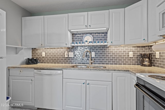 kitchen featuring range with electric stovetop, tasteful backsplash, dishwasher, sink, and white cabinets