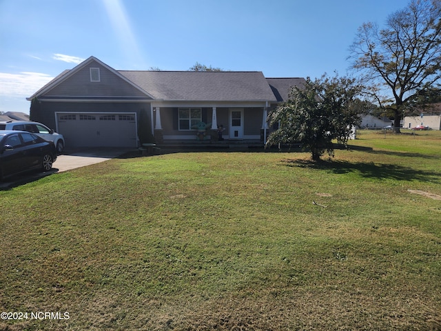 view of front of house featuring a front yard and a garage