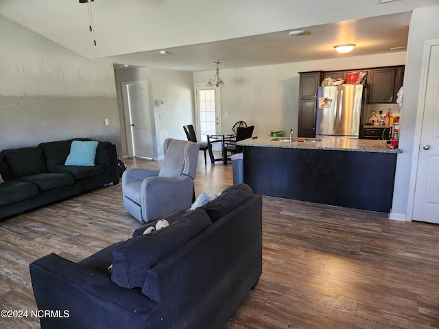 living room with sink and dark wood-type flooring