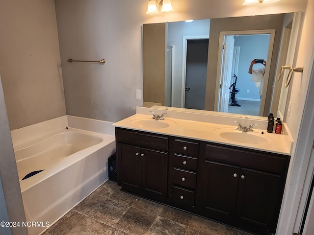 bathroom with vanity and a tub