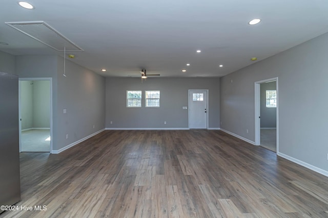 unfurnished bedroom with ceiling fan, a closet, light carpet, and multiple windows