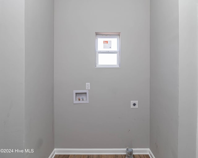 clothes washing area featuring hardwood / wood-style flooring, hookup for a washing machine, and hookup for an electric dryer