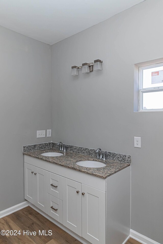 bathroom with vanity and hardwood / wood-style flooring