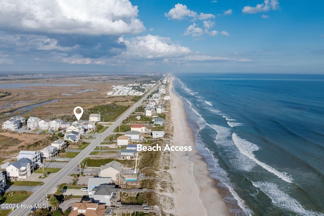 birds eye view of property with a water view and a view of the beach