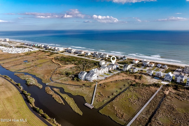 birds eye view of property featuring a water view and a beach view