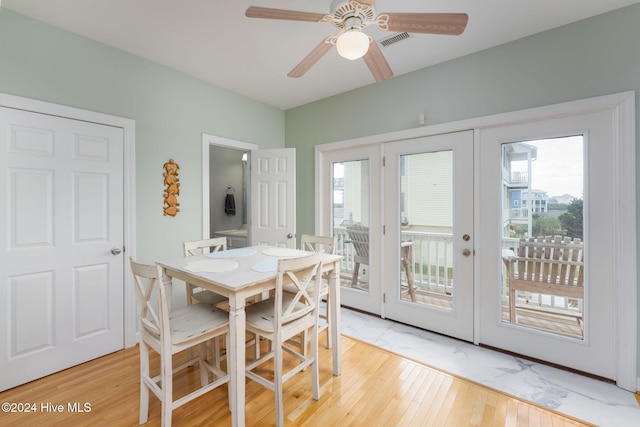 dining space featuring hardwood / wood-style floors, ceiling fan, and french doors