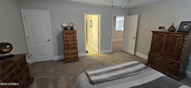 bedroom featuring light carpet and ensuite bath