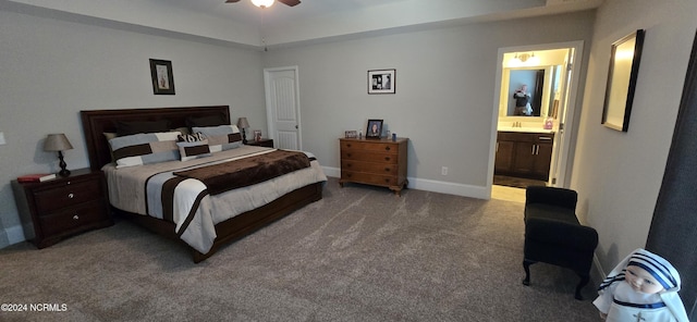 carpeted bedroom with ensuite bathroom, sink, and ceiling fan