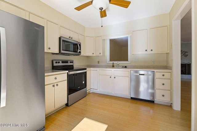 kitchen with a ceiling fan, light wood-style floors, light countertops, a sink, and stainless steel appliances