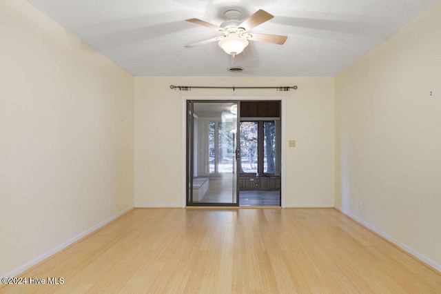 unfurnished room with light wood-type flooring and ceiling fan