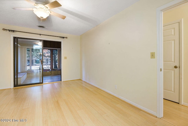 empty room featuring ceiling fan and light wood-type flooring