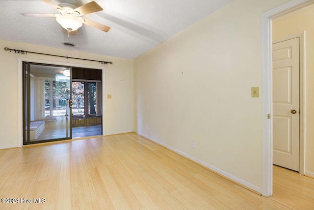 unfurnished room with baseboards, a ceiling fan, and light wood finished floors