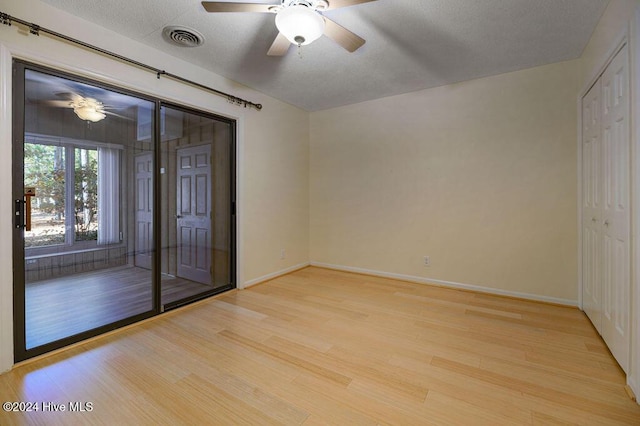 spare room with a ceiling fan, baseboards, visible vents, and light wood-style floors