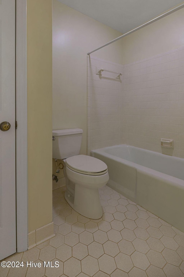 full bathroom featuring  shower combination, tile patterned floors, and toilet