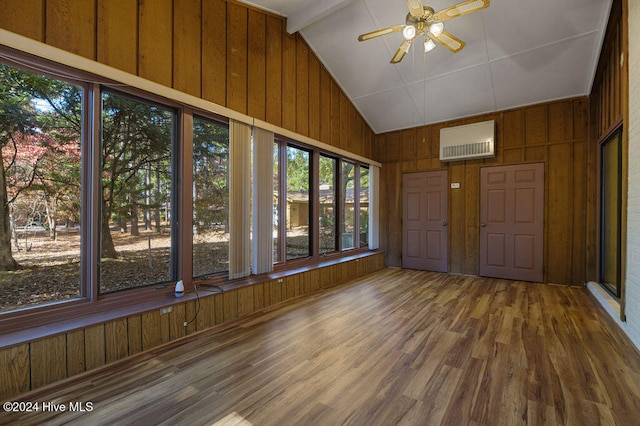 unfurnished sunroom with vaulted ceiling with beams, a wall mounted AC, and ceiling fan