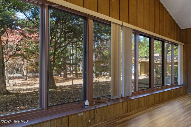 room details with hardwood / wood-style flooring and wooden walls