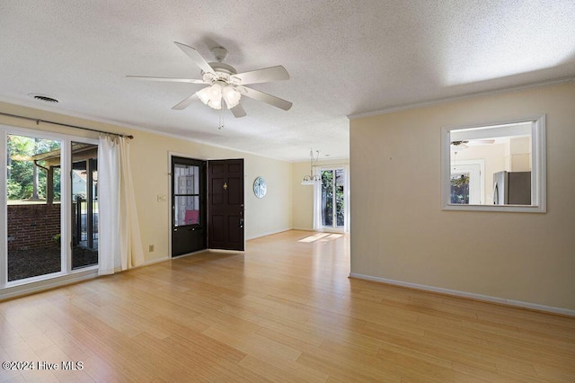 unfurnished room with ceiling fan, ornamental molding, light wood finished floors, and a textured ceiling