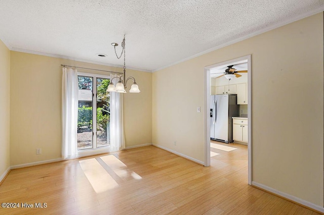 unfurnished dining area with crown molding, baseboards, light wood-type flooring, and a textured ceiling