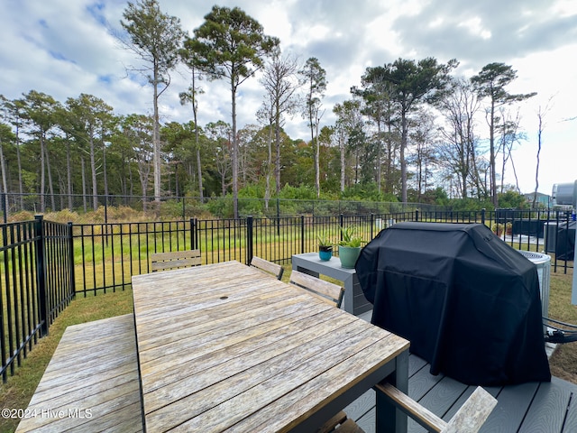 deck with grilling area and a lawn