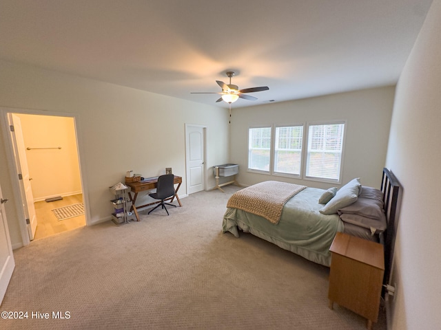 bedroom featuring ensuite bath, carpet, and ceiling fan