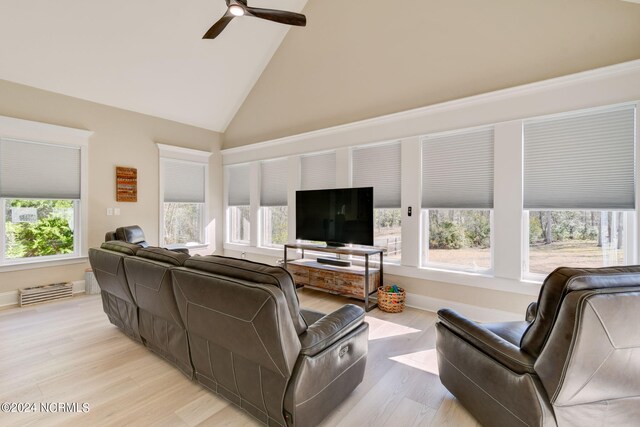 kitchen featuring stainless steel appliances, a center island, sink, and white cabinets